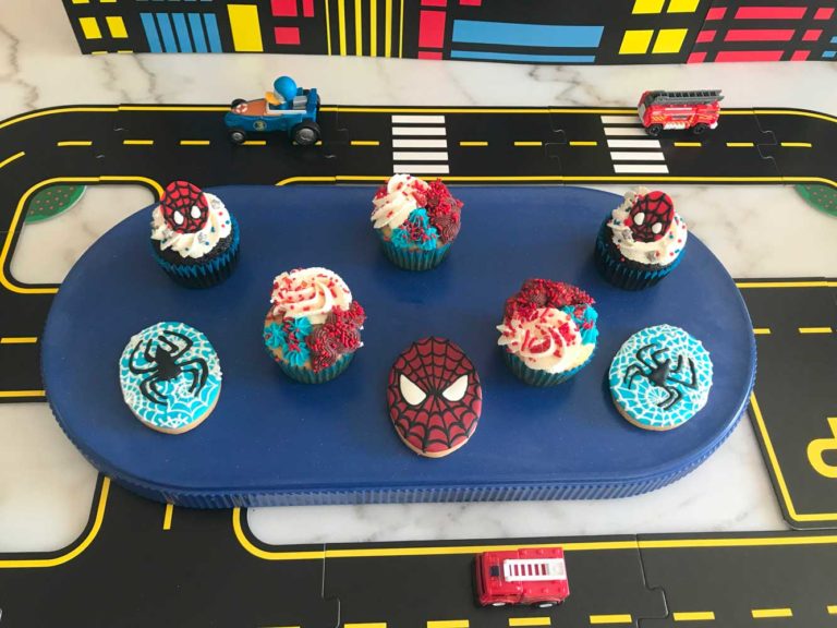 SPIDERMAN THEMED DECORATED COOKIES AND CUPCAKES STAGED WITH DECOR