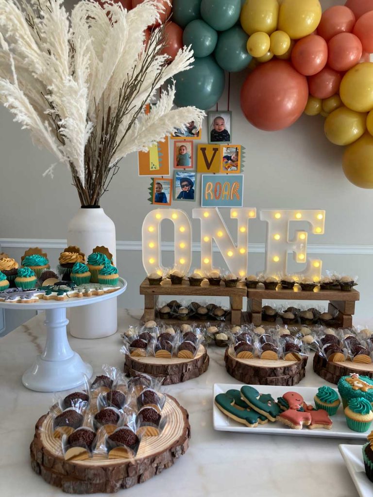 DINOSAUR THEMED DESSERT TABLE STAGED WITH DECOR AND DESSERTS